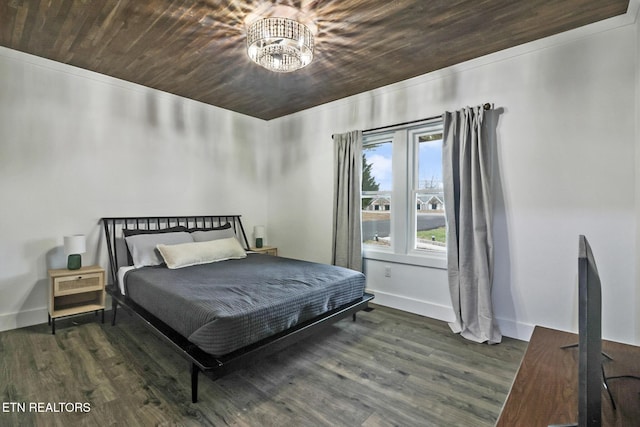 bedroom with dark wood-type flooring, wooden ceiling, and an inviting chandelier