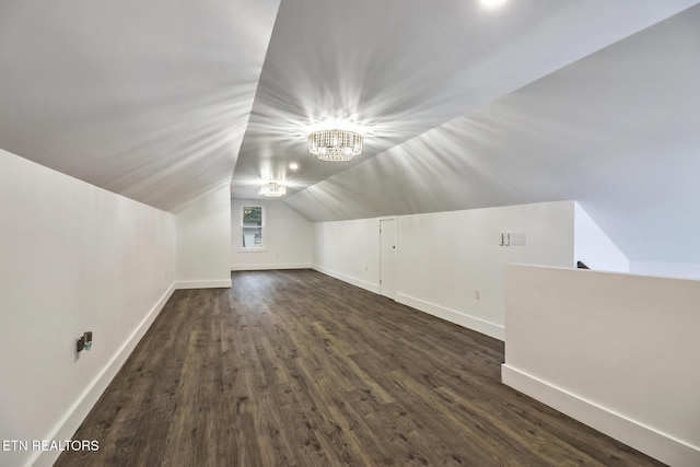 bonus room with lofted ceiling and dark hardwood / wood-style floors