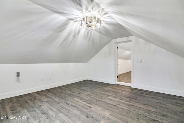 additional living space with lofted ceiling and dark hardwood / wood-style floors