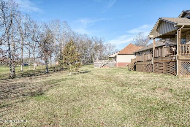 view of yard with stairs and a wooden deck