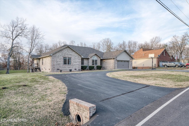 view of front of property featuring a garage, a front yard, brick siding, and roof with shingles