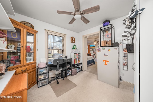 office space with light carpet and ceiling fan