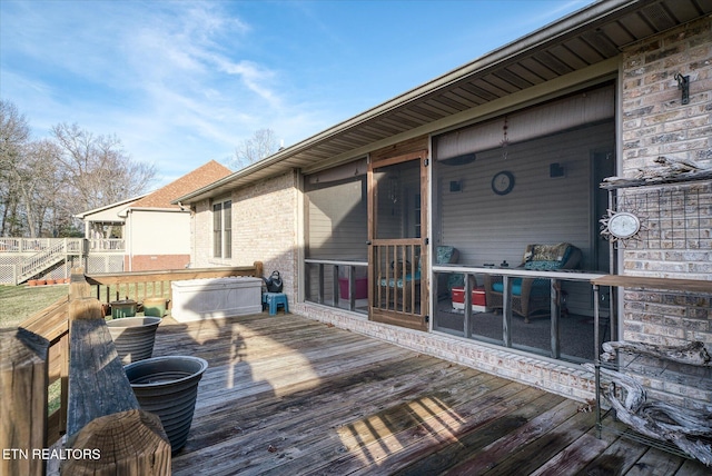 wooden terrace featuring a sunroom