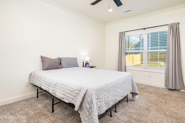 bedroom with ceiling fan, carpet, and ornamental molding