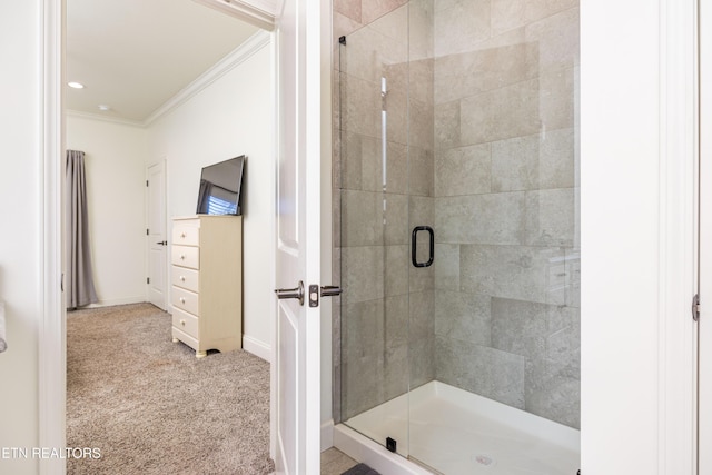 bathroom with an enclosed shower and ornamental molding