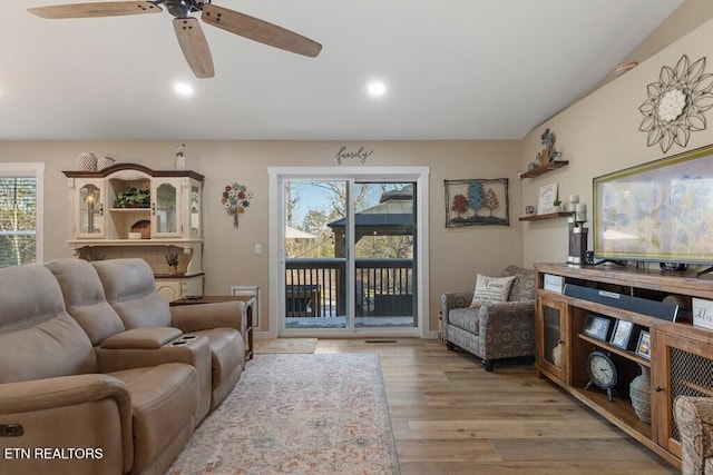 living room with ceiling fan and light wood-type flooring