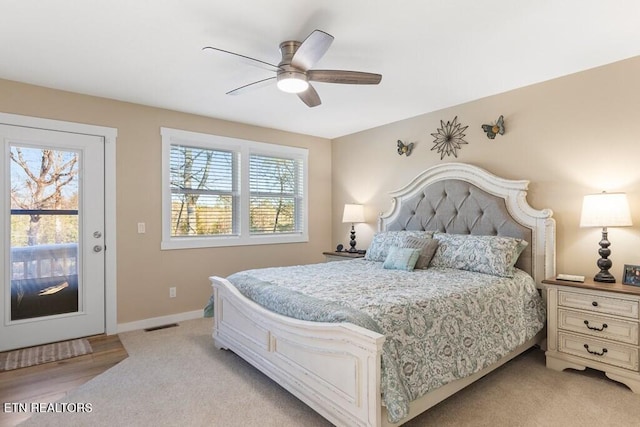 bedroom featuring ceiling fan and light carpet