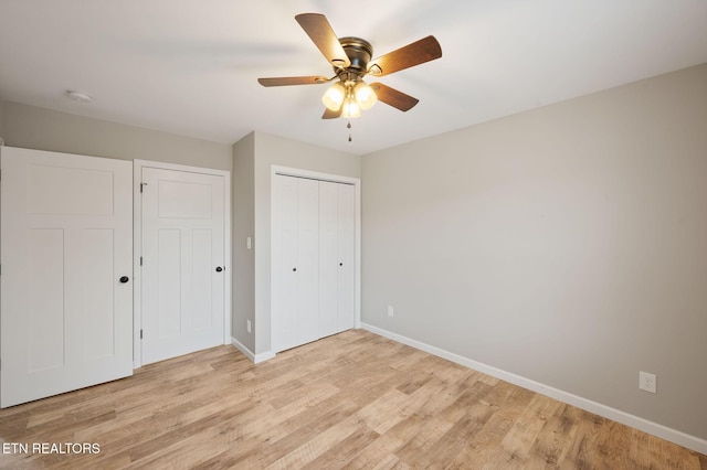 unfurnished bedroom with ceiling fan and light hardwood / wood-style floors