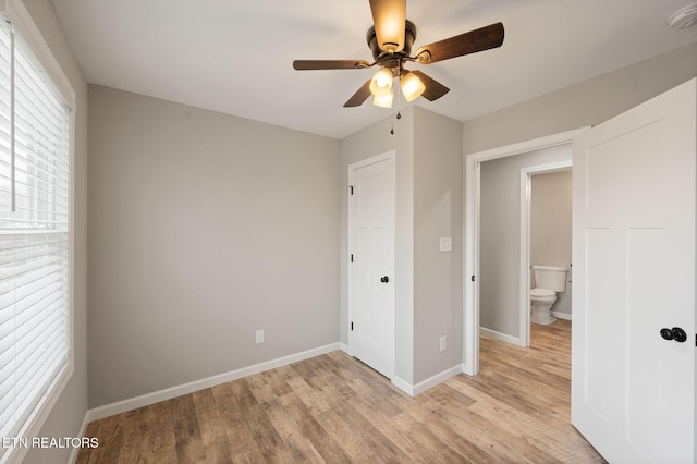 unfurnished bedroom featuring ceiling fan, light hardwood / wood-style floors, and ensuite bath