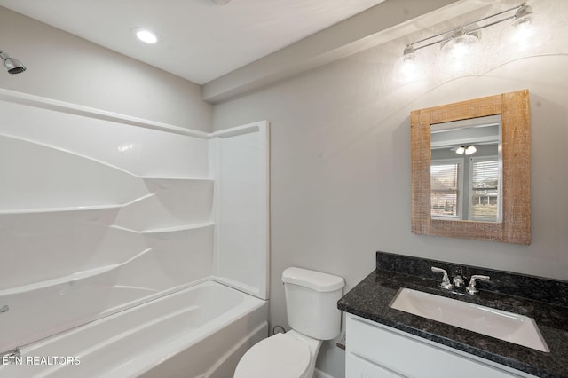 full bathroom with toilet, vanity, and shower / washtub combination