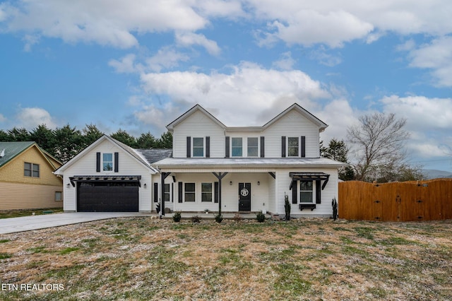 view of front facade featuring a garage, a front yard, and covered porch