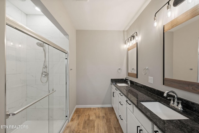 bathroom with vanity, a shower with door, and hardwood / wood-style flooring