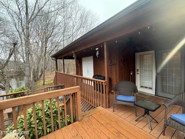 wooden deck featuring a water view