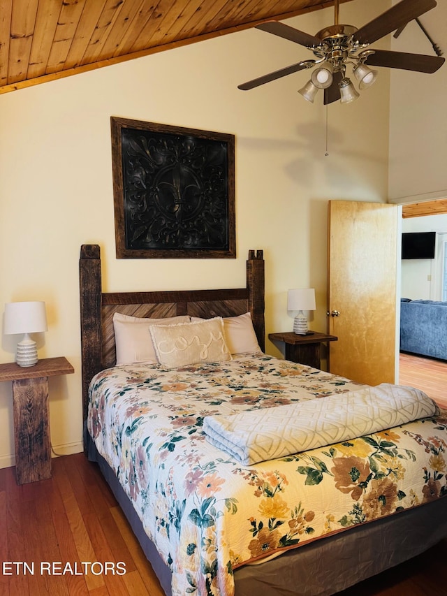 bedroom with vaulted ceiling, dark hardwood / wood-style floors, ceiling fan, and wood ceiling