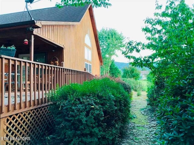 view of property exterior featuring a wooden deck