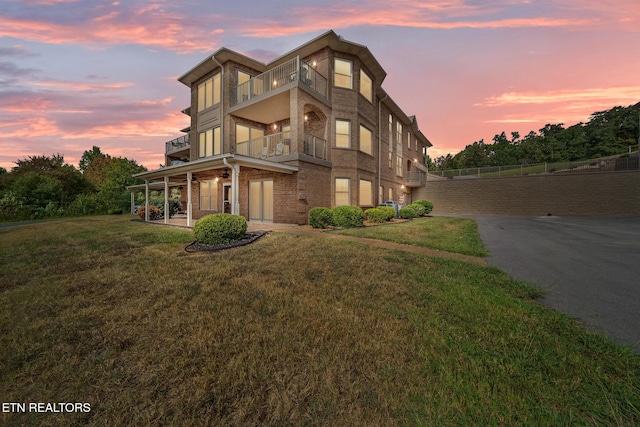 exterior space with a lawn and a balcony