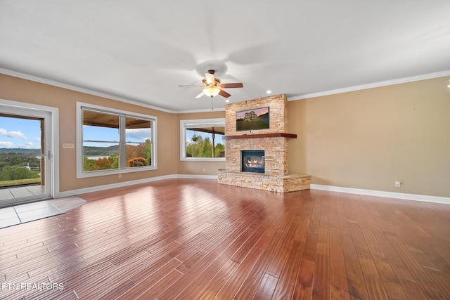 unfurnished living room featuring a fireplace, crown molding, and hardwood / wood-style floors