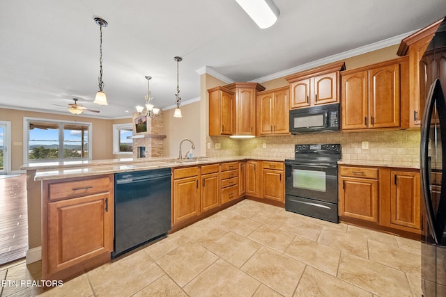 kitchen featuring pendant lighting, black appliances, kitchen peninsula, ornamental molding, and ceiling fan with notable chandelier