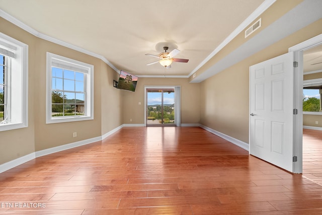 unfurnished room with light wood-type flooring, ceiling fan, and ornamental molding