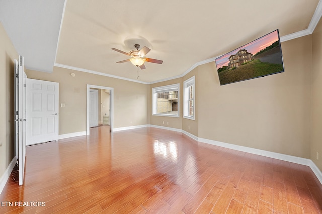 empty room featuring ceiling fan, hardwood / wood-style flooring, and ornamental molding