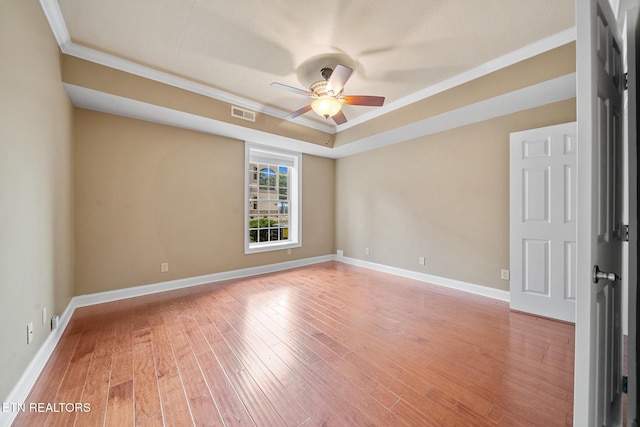 spare room with ceiling fan, crown molding, and hardwood / wood-style floors