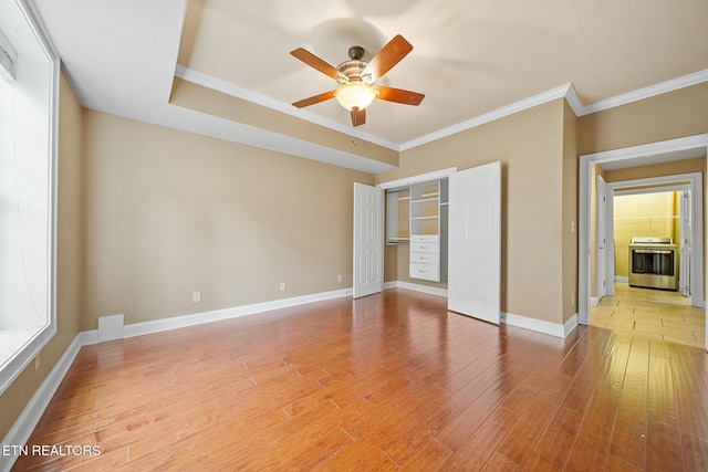 unfurnished bedroom featuring ceiling fan, wood-type flooring, a closet, and ornamental molding