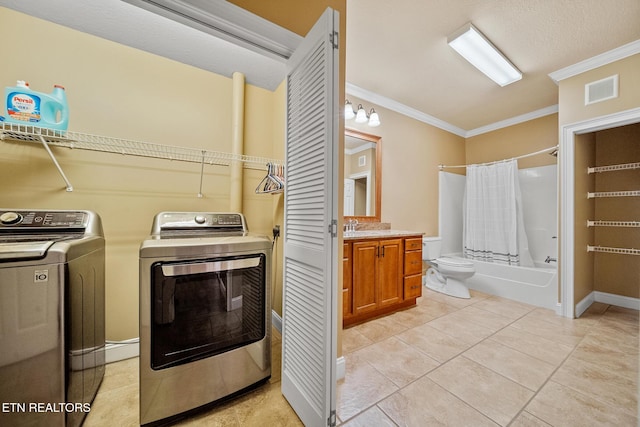 laundry room featuring washer and dryer, sink, ornamental molding, a textured ceiling, and light tile patterned floors