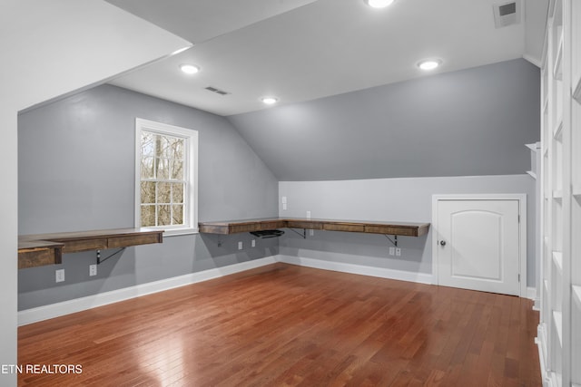 bonus room with visible vents, vaulted ceiling, and hardwood / wood-style flooring