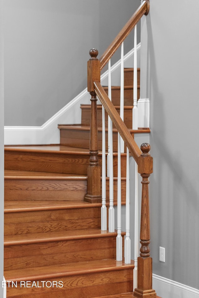 staircase featuring baseboards
