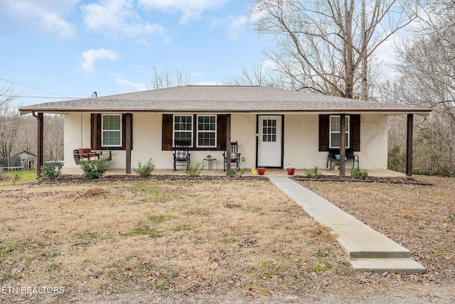 single story home with a front yard and covered porch