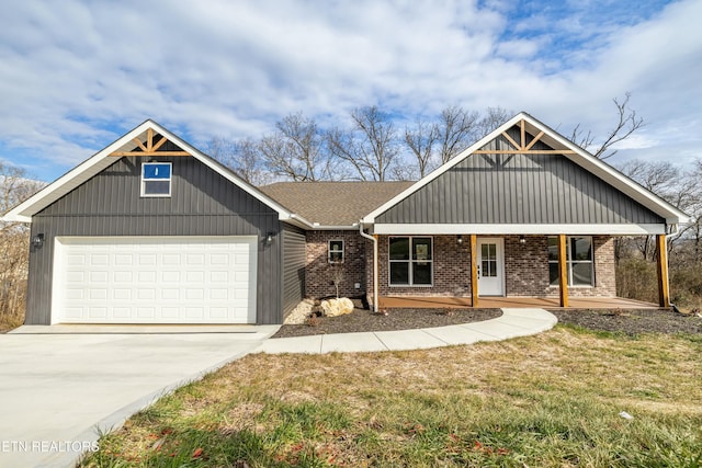 view of front of property featuring a garage, a front lawn, and covered porch