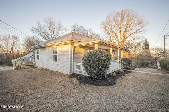 view of property exterior featuring a wooden deck