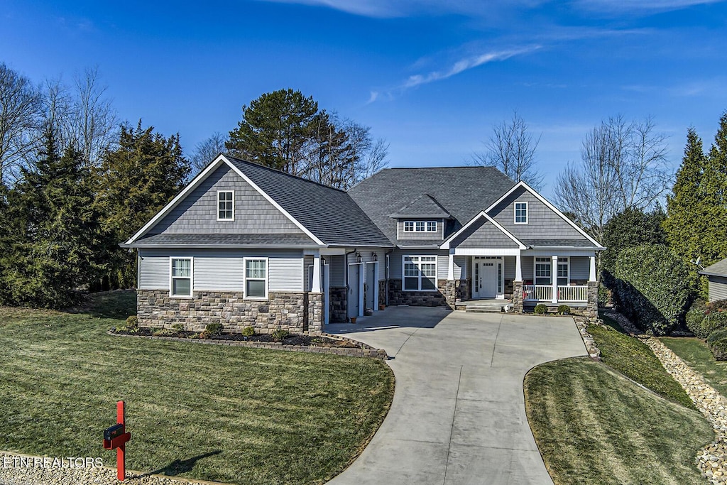 craftsman-style house with covered porch and a front lawn