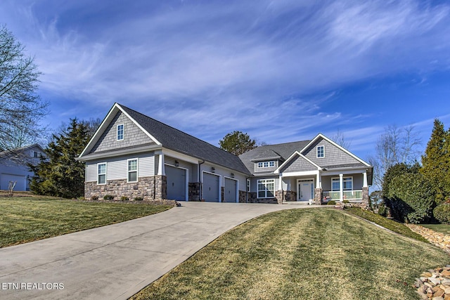 craftsman house featuring a garage, covered porch, and a front lawn