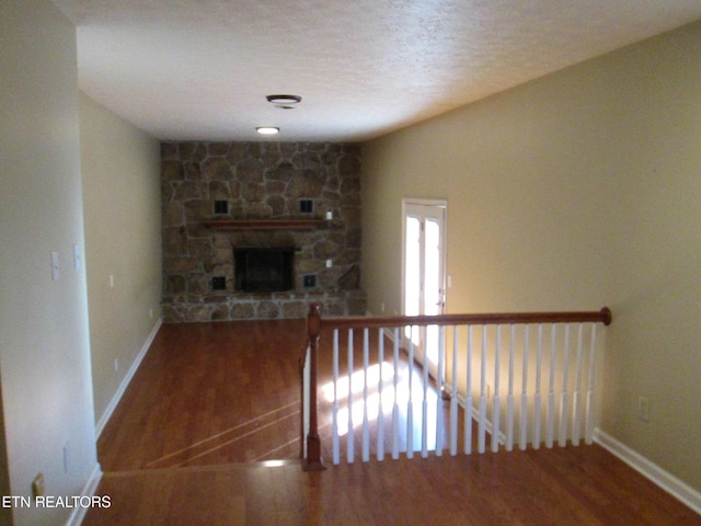 interior space with a fireplace and hardwood / wood-style flooring