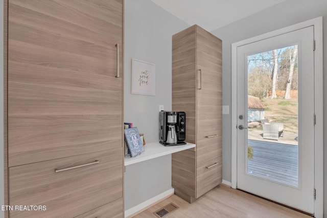 doorway to outside featuring light wood-type flooring