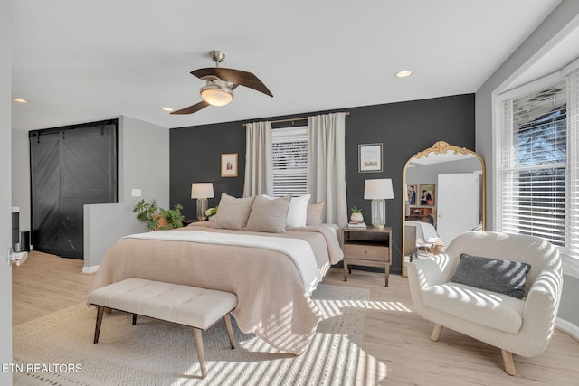 bedroom with ceiling fan and light hardwood / wood-style floors