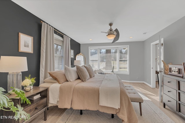 bedroom with ceiling fan and light hardwood / wood-style floors