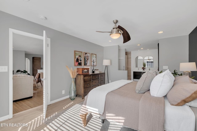 bedroom with ceiling fan and light wood-type flooring