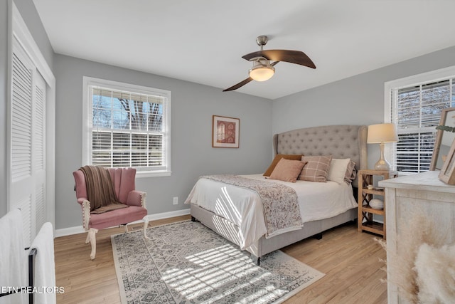 bedroom with ceiling fan and light hardwood / wood-style floors