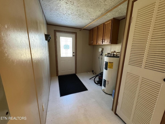 washroom featuring cabinets and electric water heater