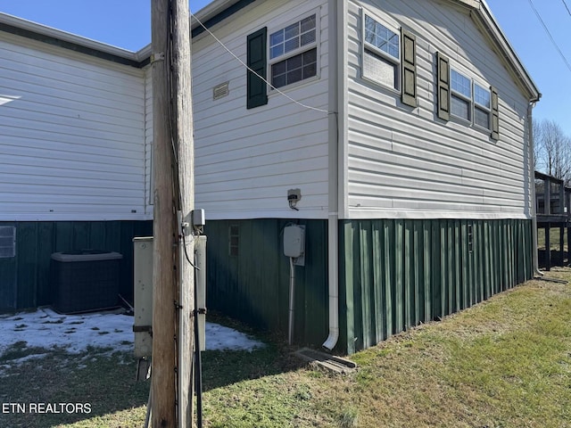 view of home's exterior with central AC and a yard