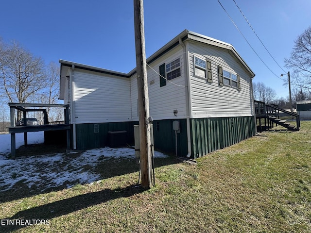 view of side of home featuring a lawn