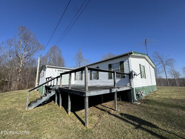 exterior space featuring a lawn and a wooden deck