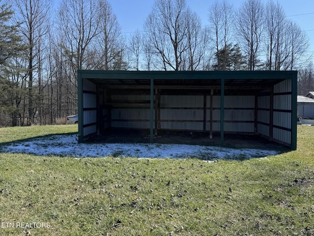 view of outdoor structure featuring a lawn