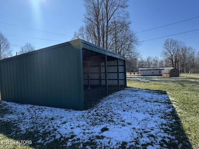 snow covered structure featuring a lawn