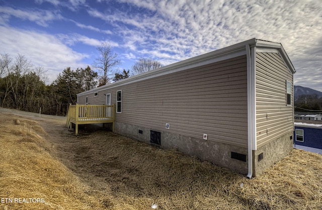 view of side of property with a deck