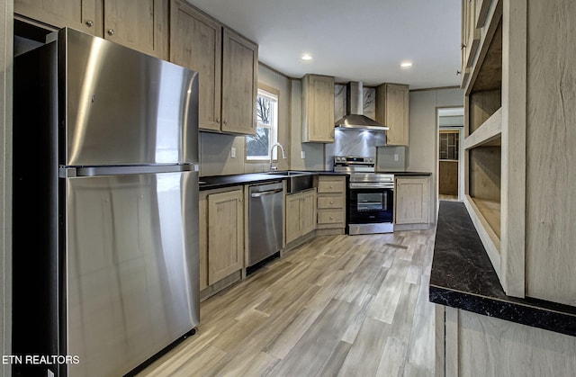 kitchen featuring wall chimney exhaust hood, light brown cabinetry, sink, light hardwood / wood-style flooring, and stainless steel appliances