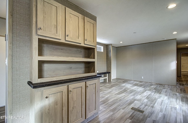 kitchen with light hardwood / wood-style flooring and light brown cabinets