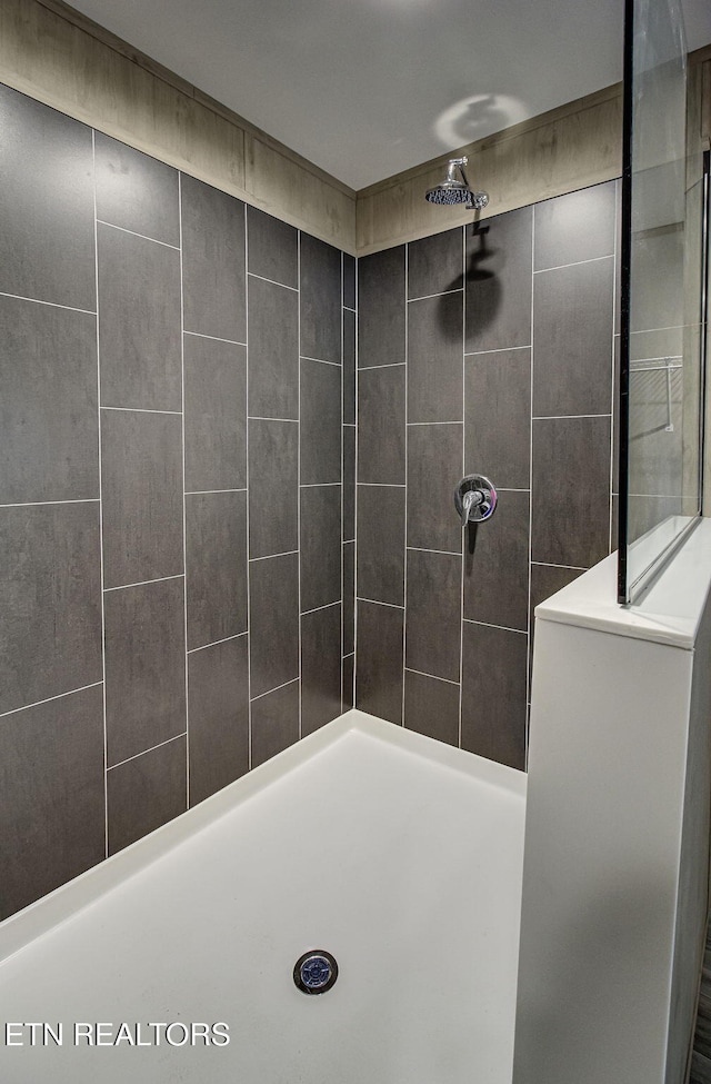 bathroom with a tile shower